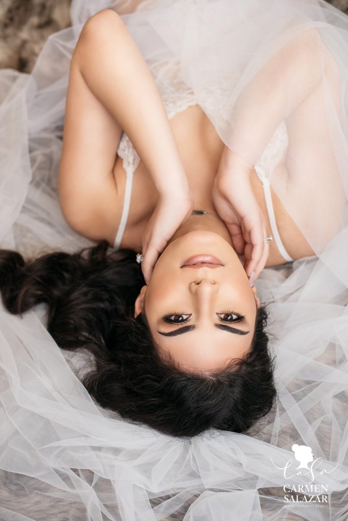 Bridal Boudoir Photo Inspiration in Sacramento by Carmen Salazar; brunette in white lingerie with white veil