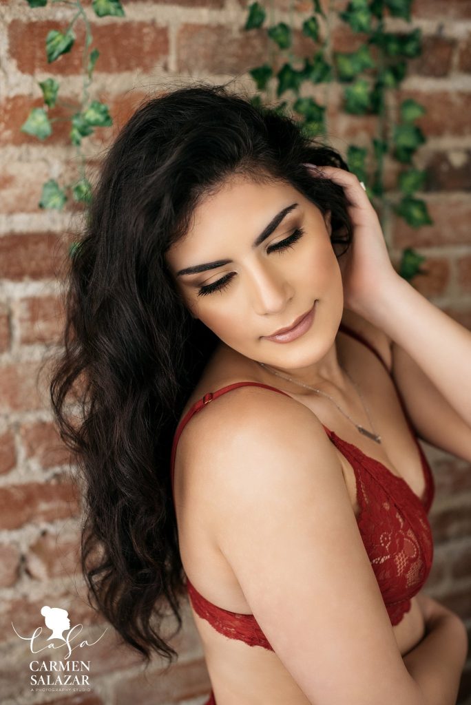 Bridal Boudoir Photo Inspiration in Sacramento by Carmen Salazar; brunette in red two piece lacey lingerie, close up