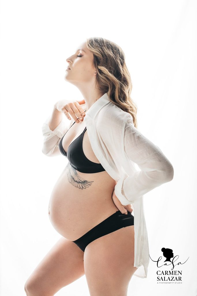 Blonde woman in black lingerie and white button down; maternity boudoir, Carmen Salazar Photography