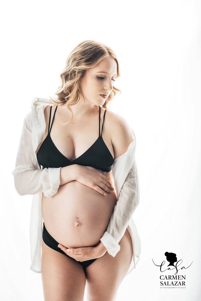 Blonde woman in black lingerie and white button down; maternity boudoir, Carmen Salazar Photography