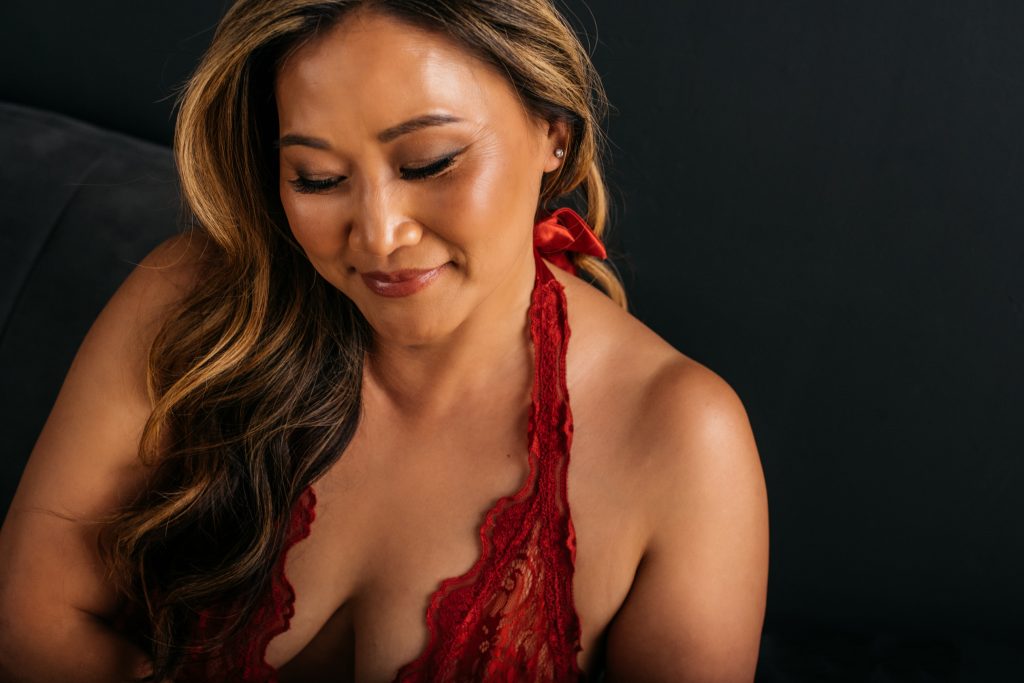 Sexy Boudoir Portrait, woman in red lingerie with black backdrop, Carmen Salazar Photography