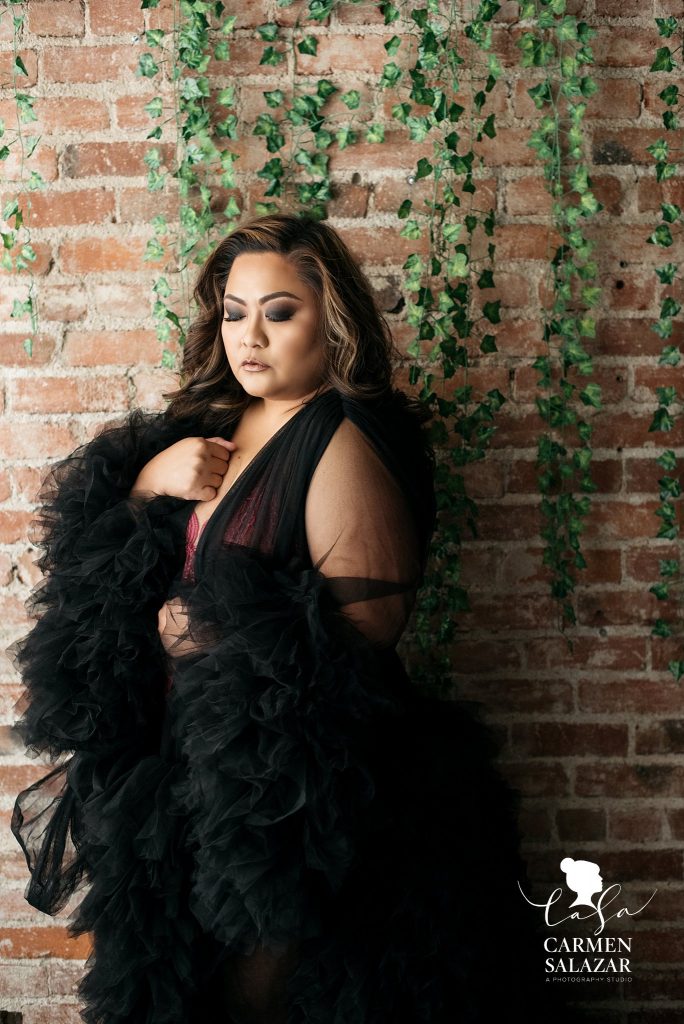 brunette plus sized model in black elegant robe; luxury boudoir experience