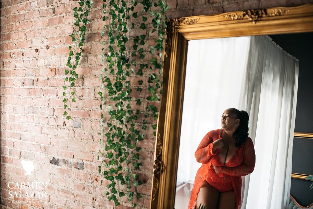 Woman in jewel-toned lingerie in front of antique mirror; Sacramento boudoir by Carmen Salazar