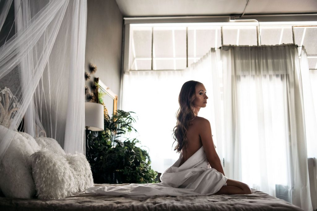 Woman posing Between the Sheets Non-Lingerie Outfits for Boudoir Photography by Carmen Salazar
