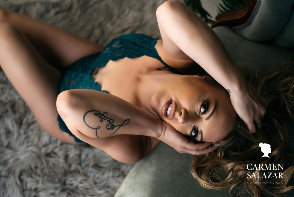 Woman in Teal bodysuit against antique teal couch; photography by Carmen Salazar