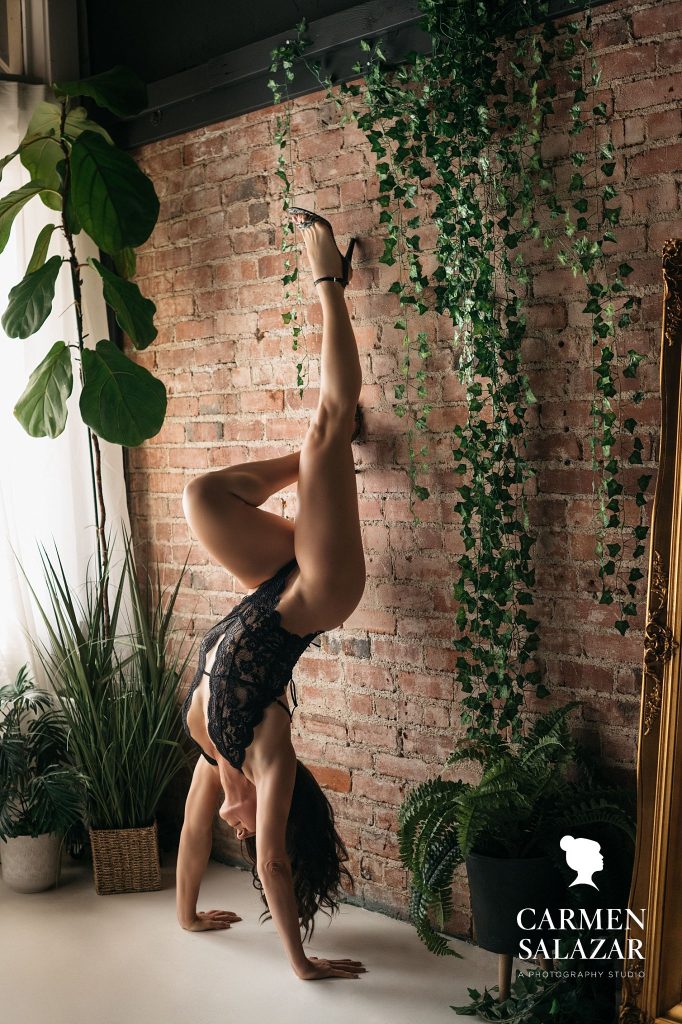 woman in black lace bodysuit doing a handstand against a brick wall; branding to boudoir, luxury photography by Carmen Salazar