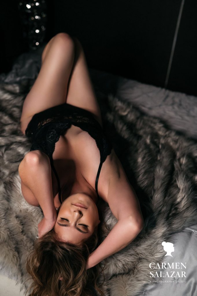 Woman in black teddy on modern bed, Carmen Salazar Photography