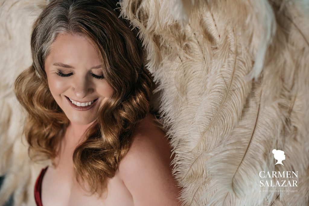 woman in 50’s in angel wings and red bodysuit; photography by Carmen Salazar