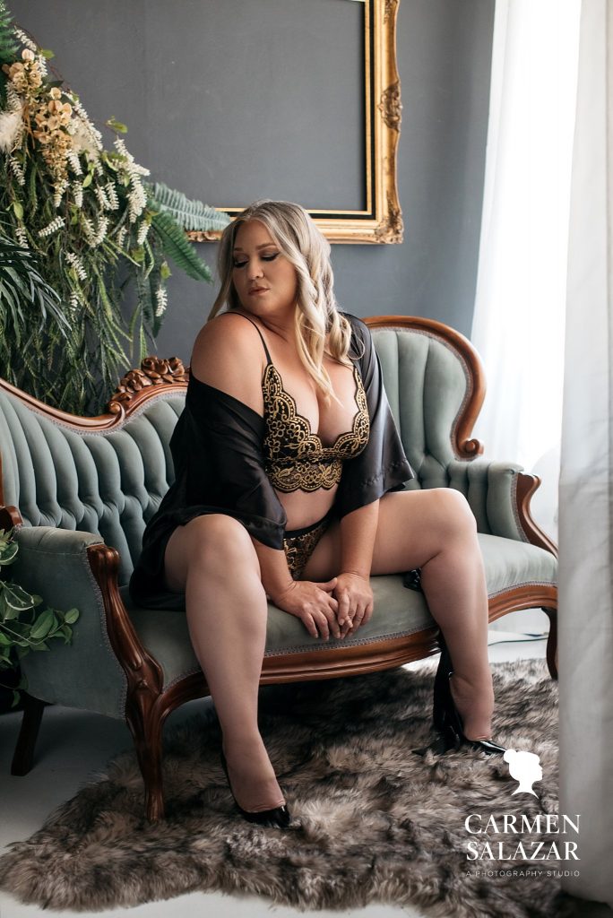 woman in gold embroidered black lingerie with vintage couch; How to Overcome Common Boudoir Session Fears, photography by Carmen Salazar
