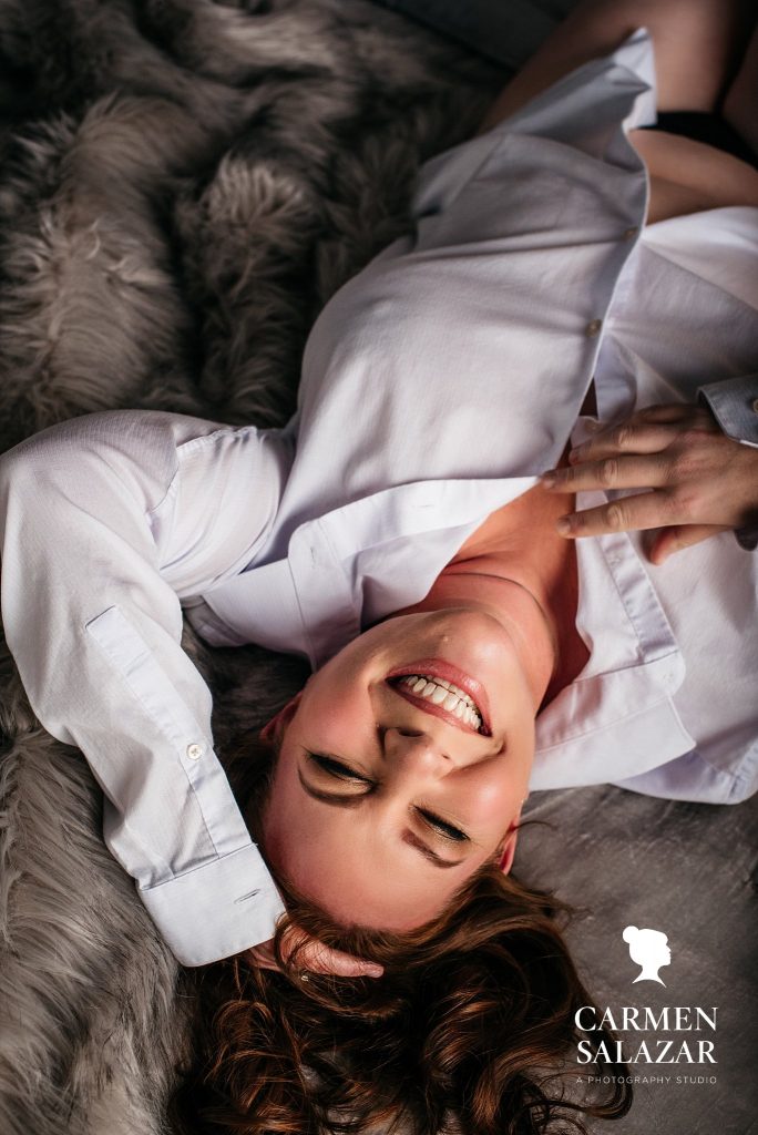 Woman in men's white button down shirt; have a blast with boudoir photography by Carmen Salazar