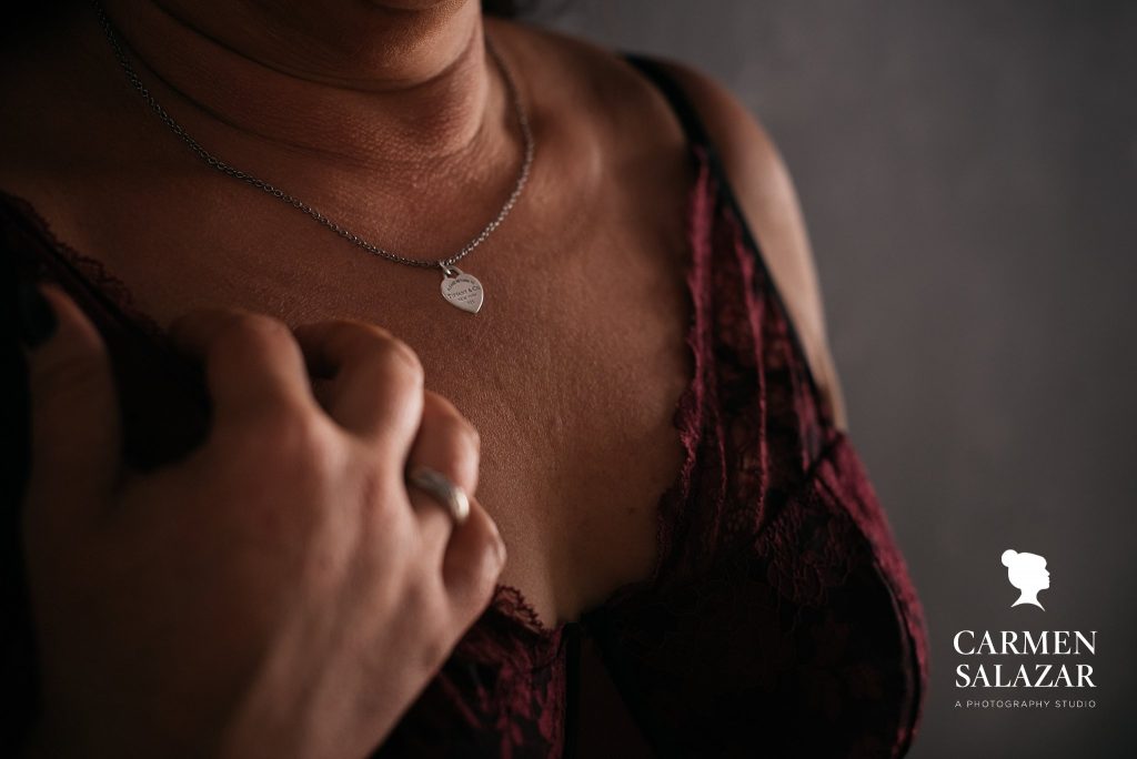 Show off your personality through boudoir photography; woman in v-neck red shirt and necklace; by Carmen Salazar