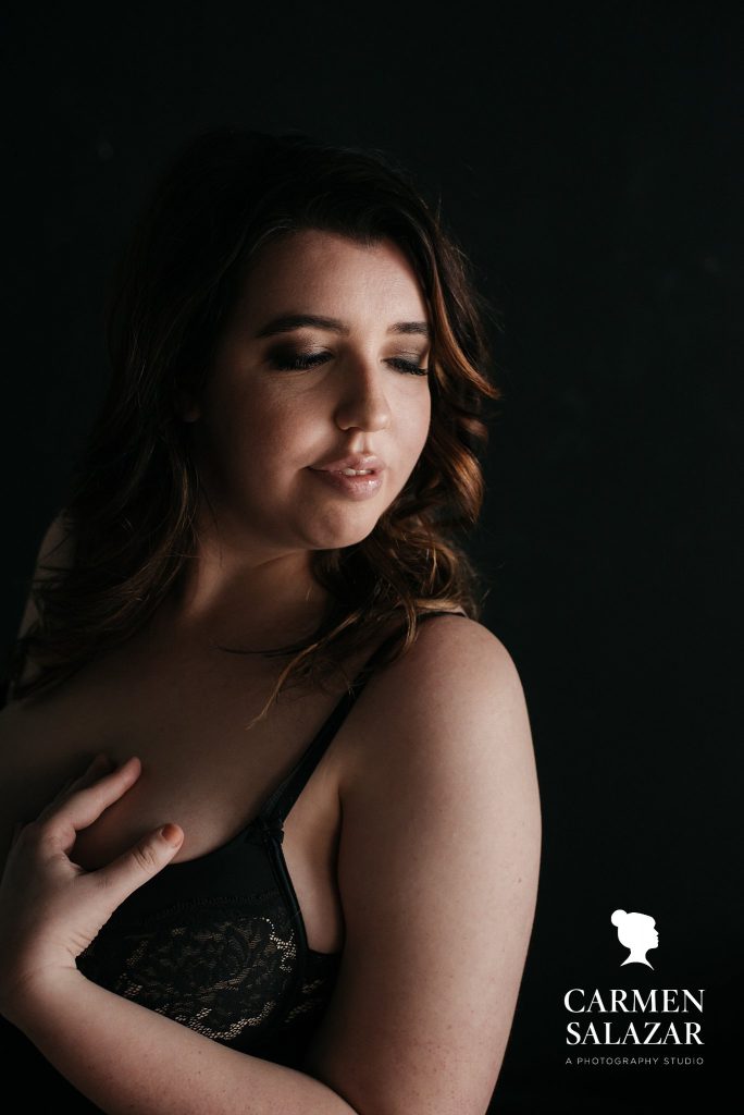 Brunette in black bra and black background;  What if I Don’t Like How I Look In My Boudoir Photos  Boudoir photography by Carmen Salazar