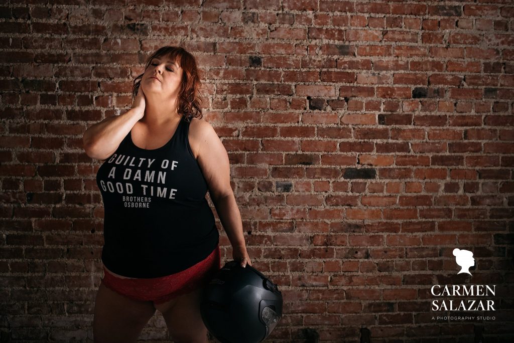 Curvy woman in graphic t-shirt and motorcycle helmet; Celebrate Your Beautiful Self by Carmen Salazar