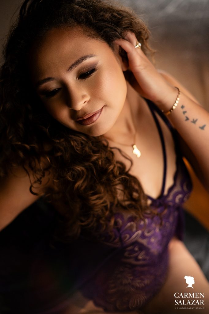 Woman in purple with curly hair